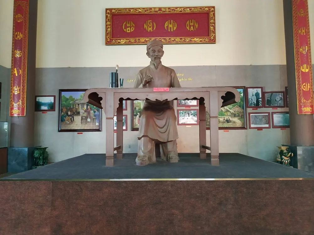 Không gian trưng bày và tượng gỗ khắc họa chân dung Thủ khoa Bùi Hữu Nghĩa trong đền thờ